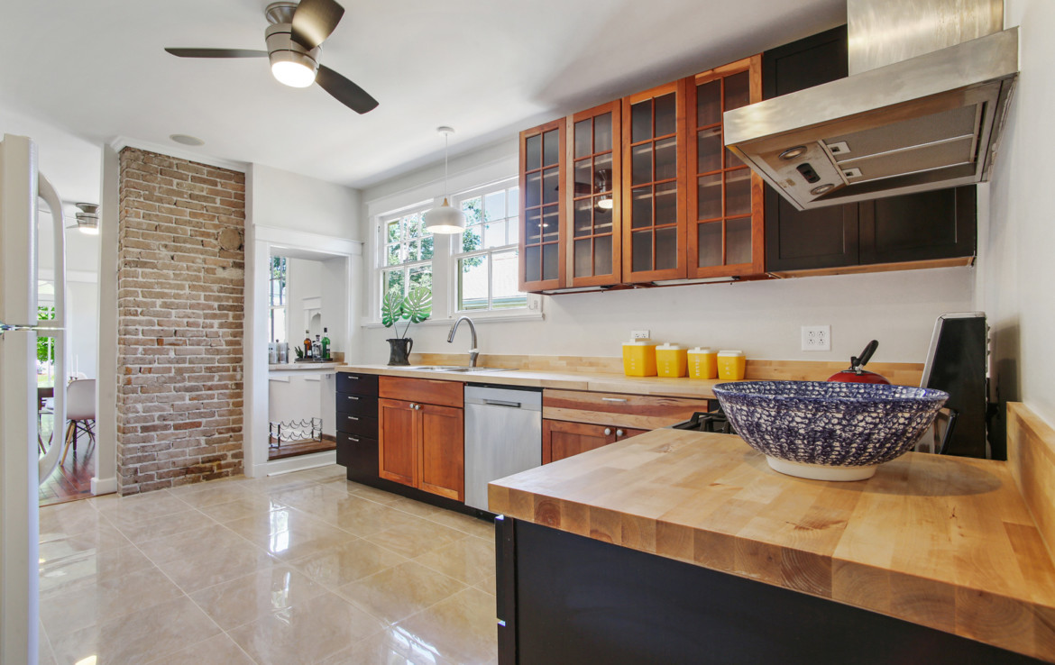 Kitchen with wood counter tops and exposed brick walls