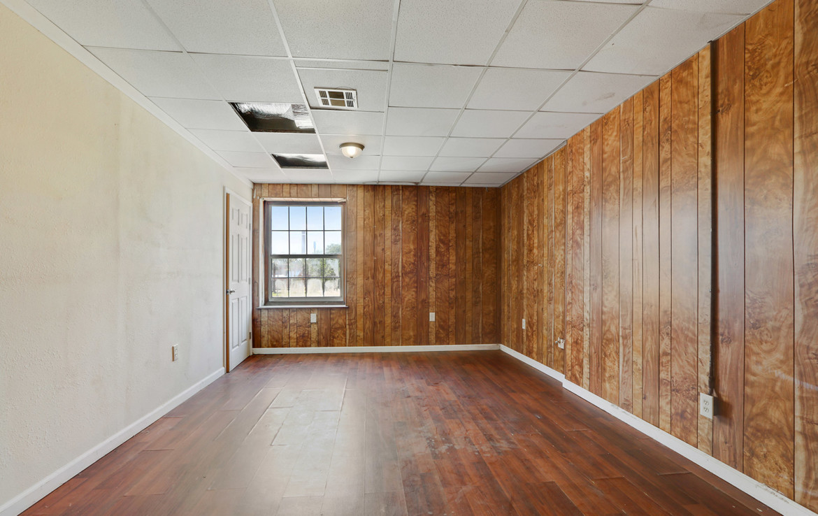 Unfurnished room with wood panel walls