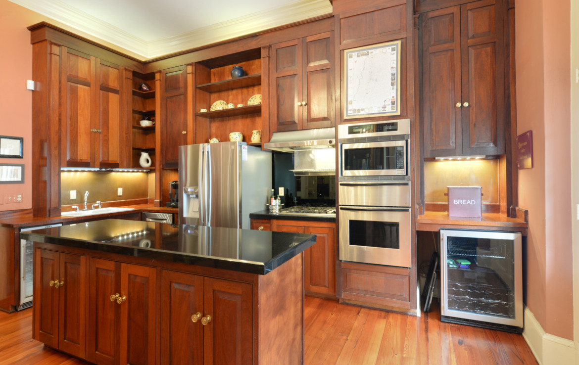 Angled view of kitchen with wooden cabinets