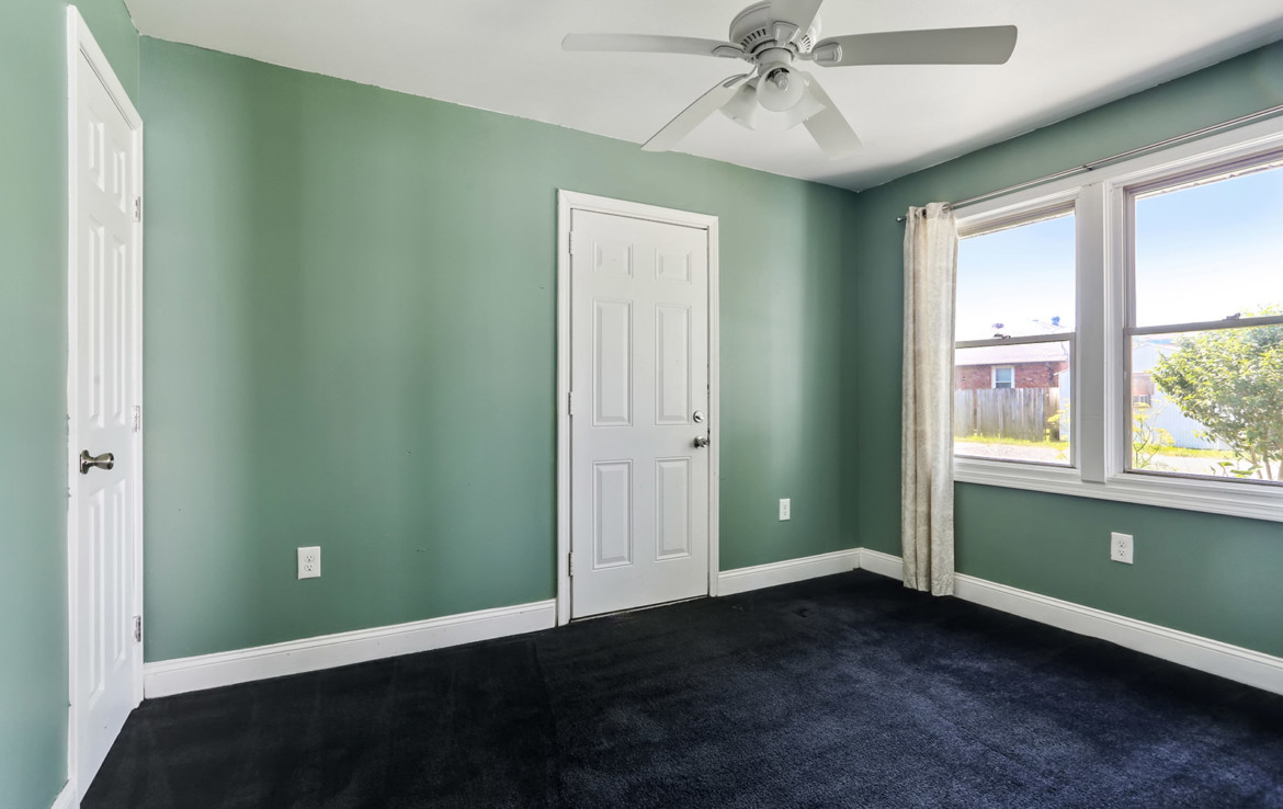 Unfurnished bedroom with green walls