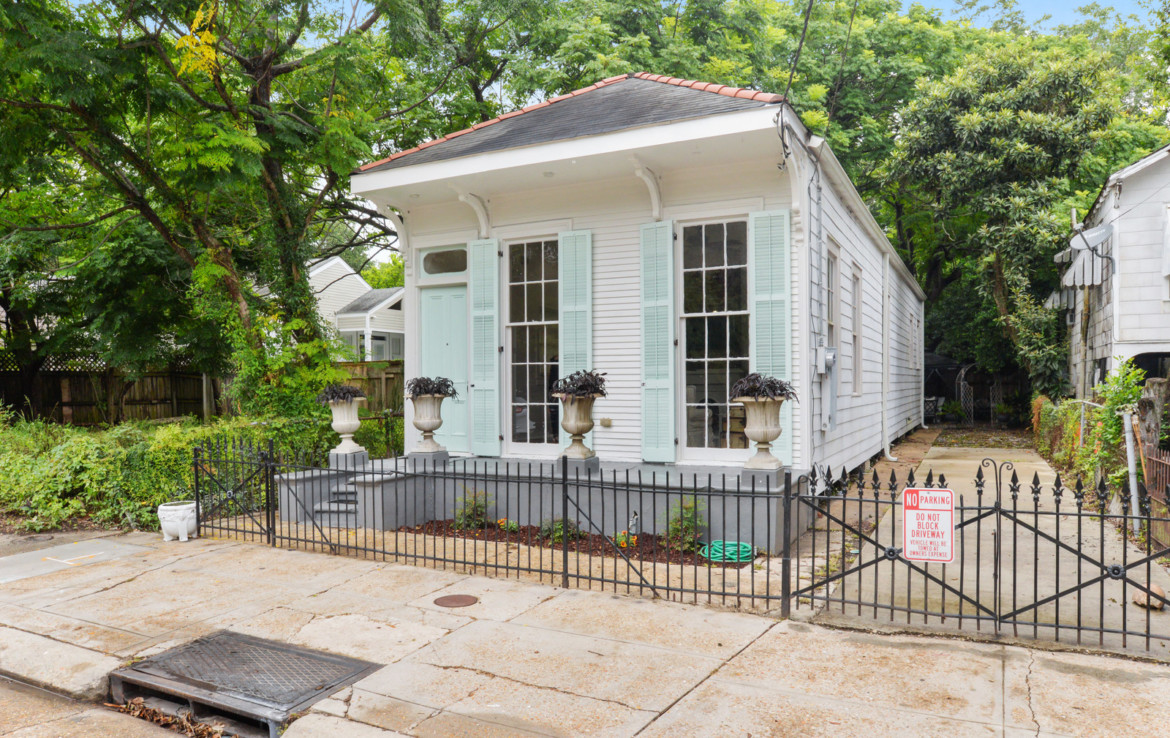 Angled view of exterior shotgun house with driveway