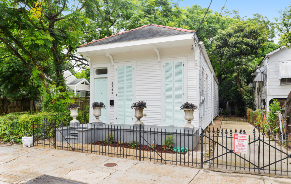 Angled view of exterior shotgun house with driveway