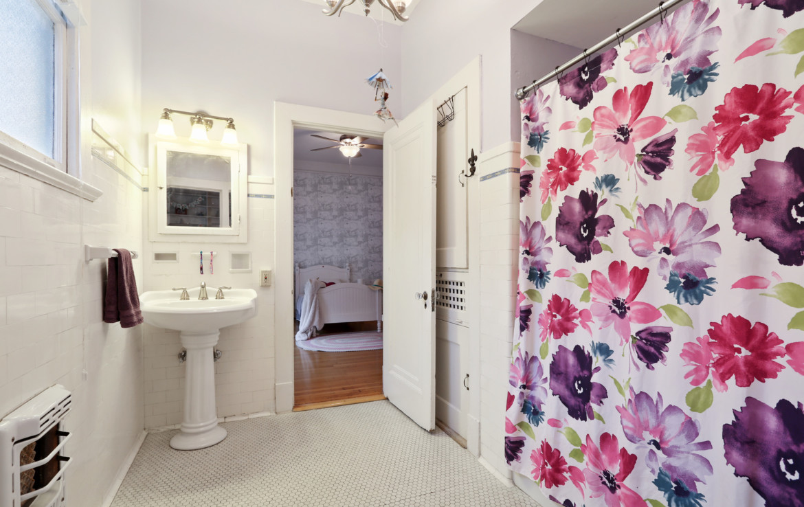 Bathroom with sink and floral shower curtain