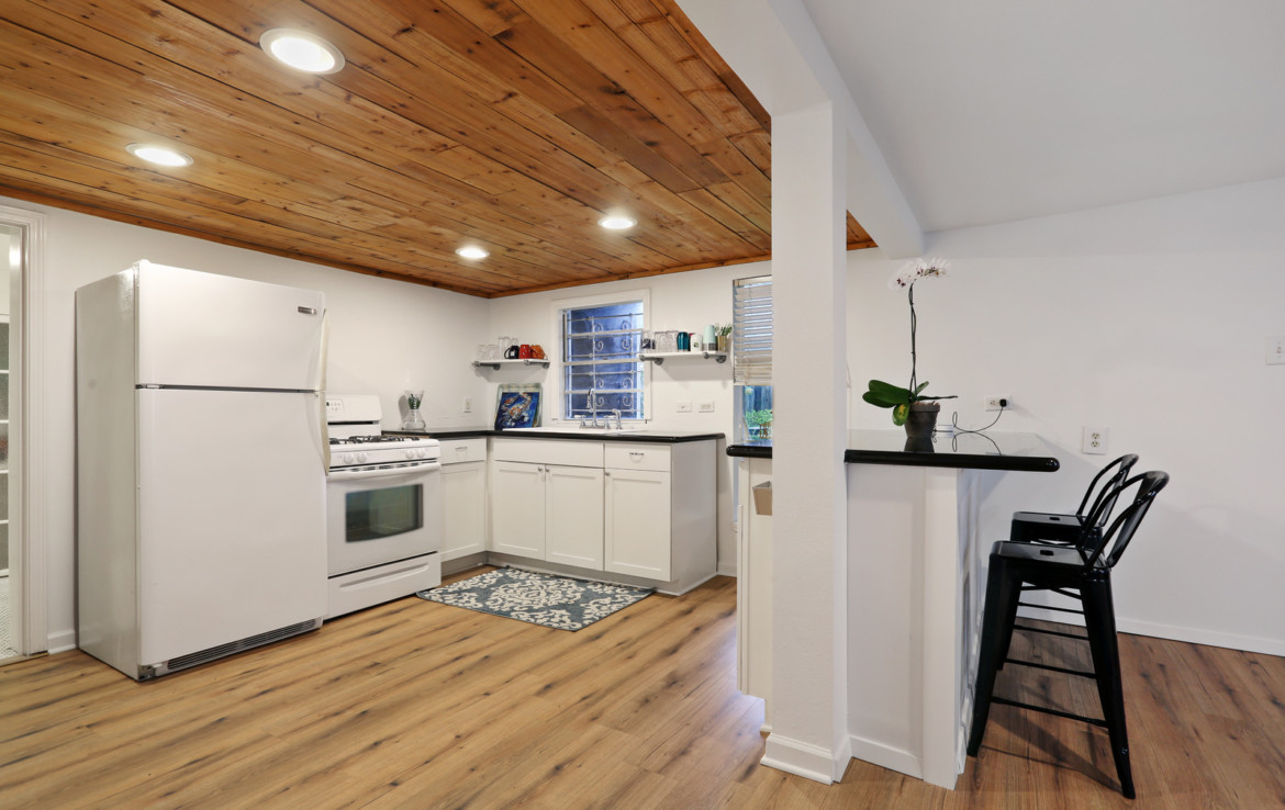 White kitchen with wooden ceiling panels