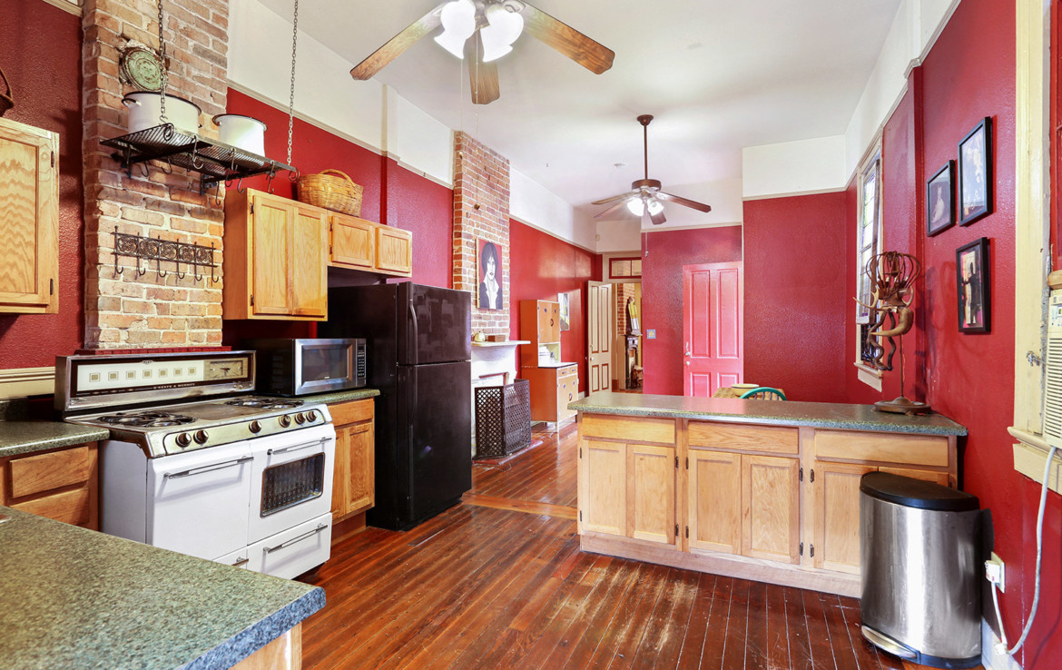 Kitchen with the red walls and exposed brick
