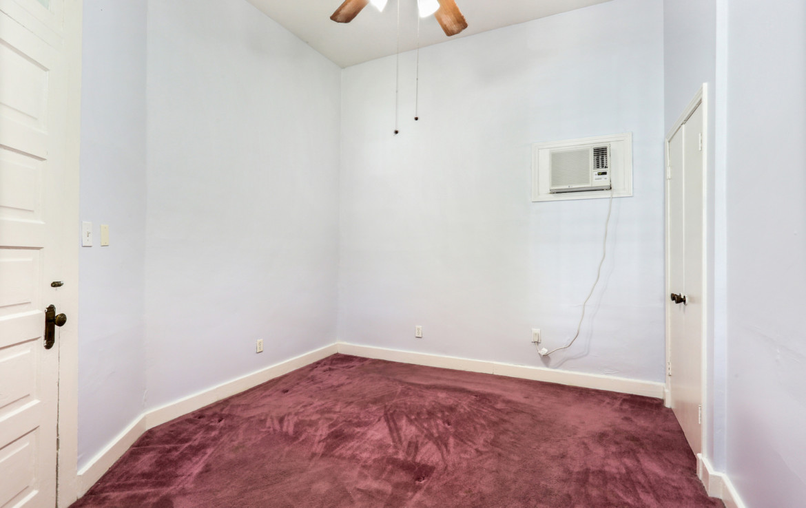Unfurnished bedroom with burgundy carpet