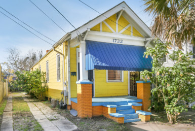 Angled view of yellow house