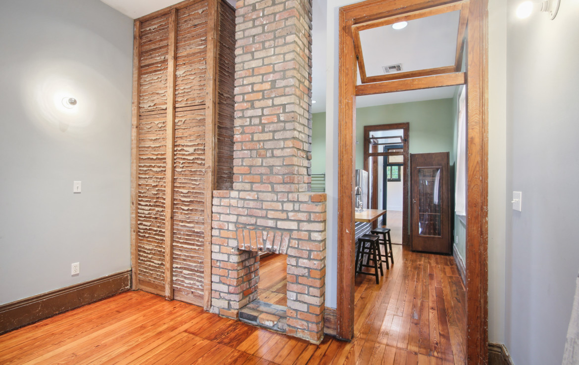 Unfurnished room with expose brick