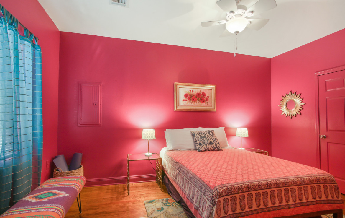 Furnished bedroom with hot pink walls