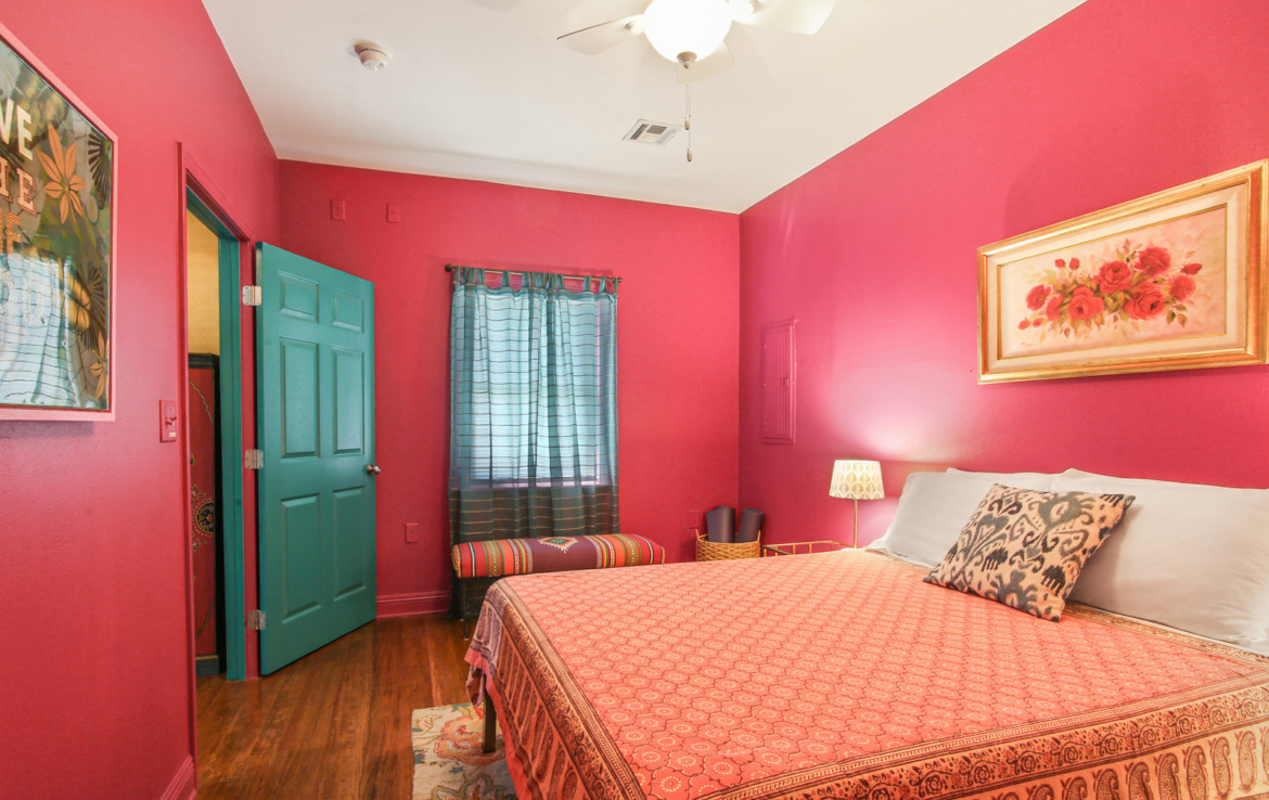 Furnished bedroom with hot pink walls