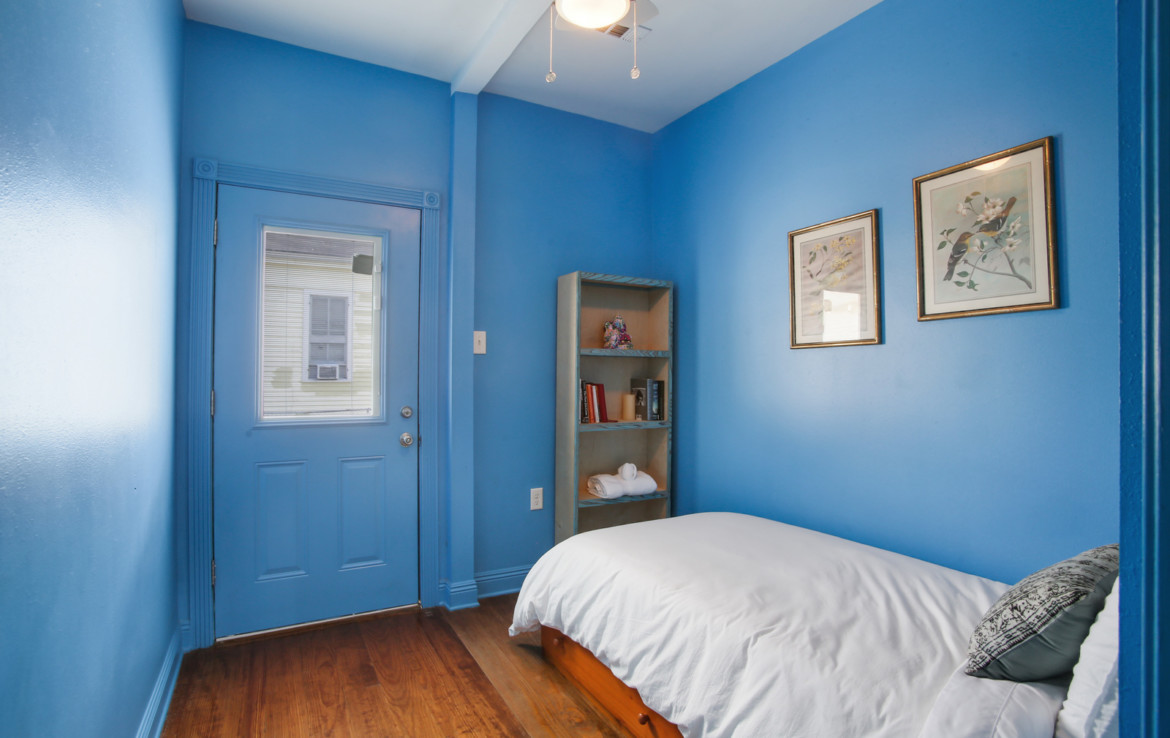 Furnished bedroom with blue walls