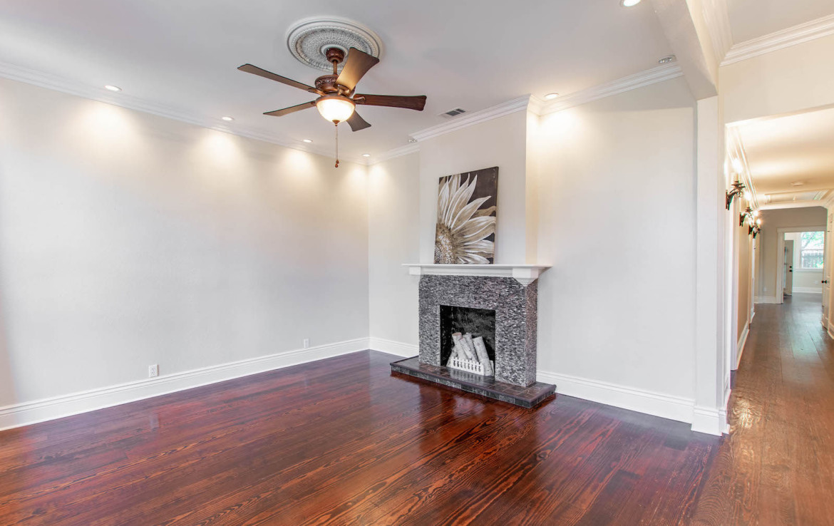 Angled view of unfurnished living room with fireplace