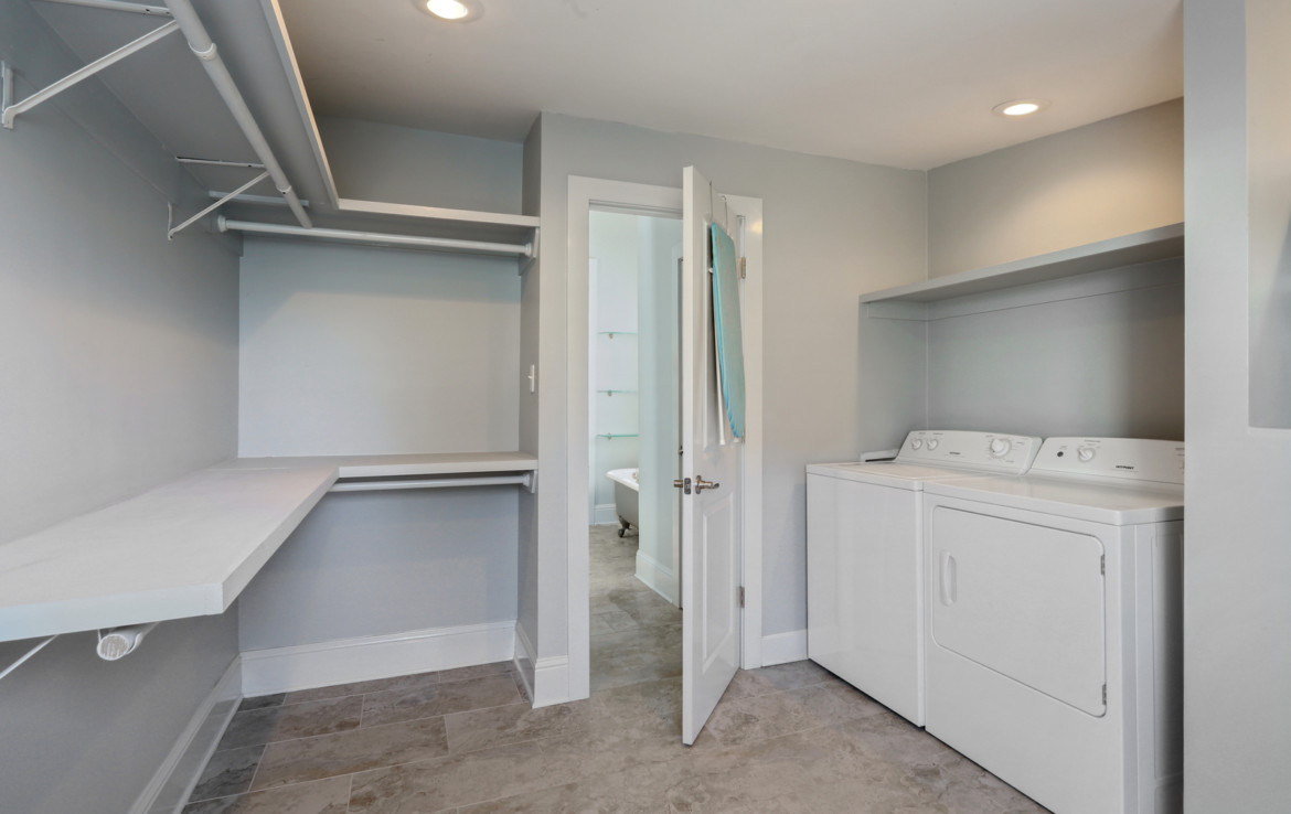 Laundry room with grey walls and shelving