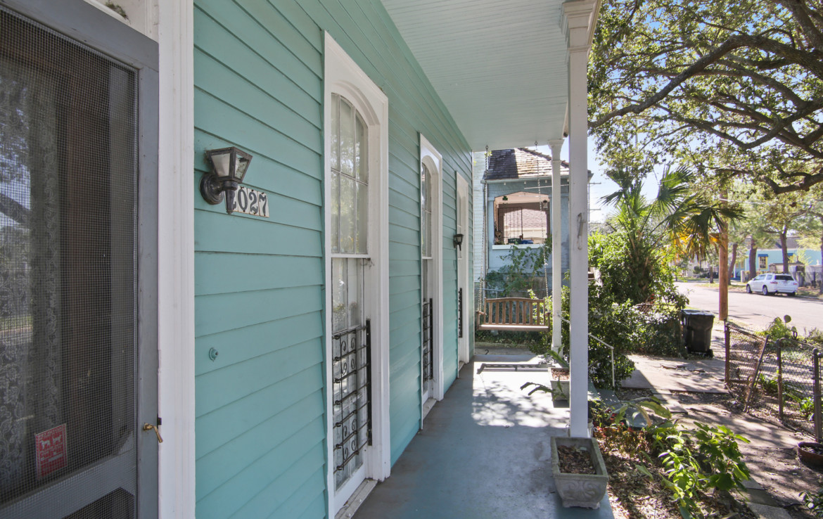 Exterior of teal house with porch