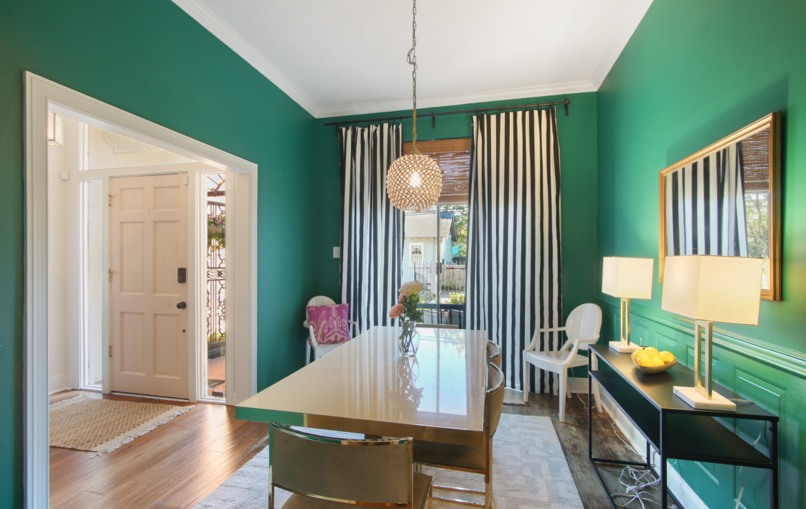 Furnished dining room with green walls