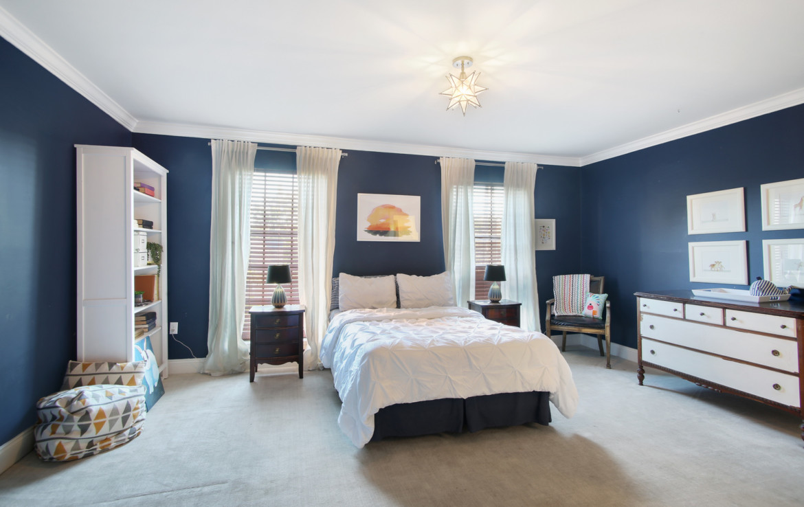 Furnished bedrooms with navy blue walls