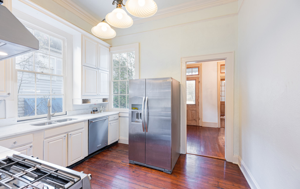 Angle view of kitchen with stainless steel refrigerator