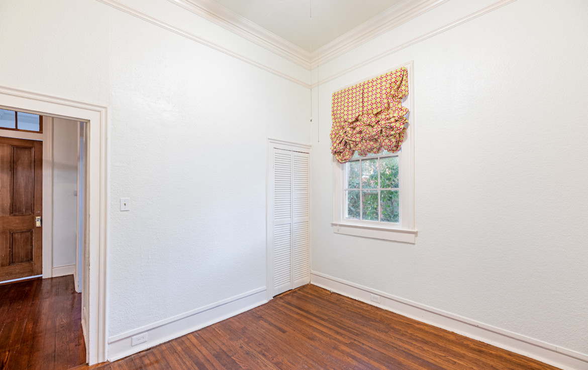 Unfurnished white room with a decorative window valance