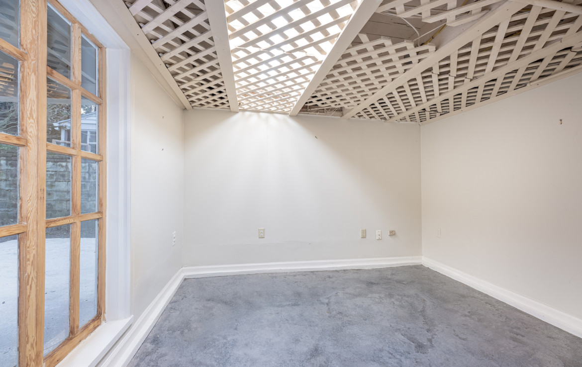 Unfurnished room with lattice top vinyl panels on ceiling