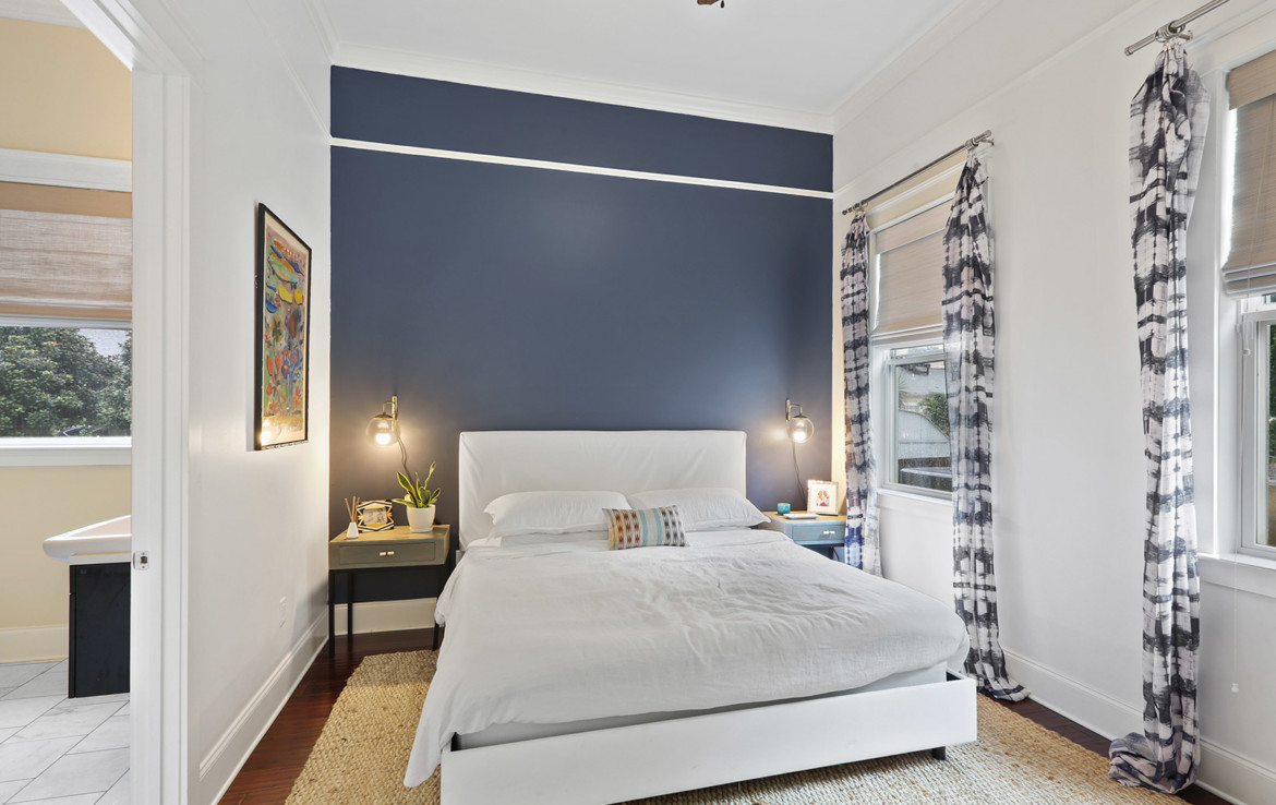 bedroom with white walls and one blue wall