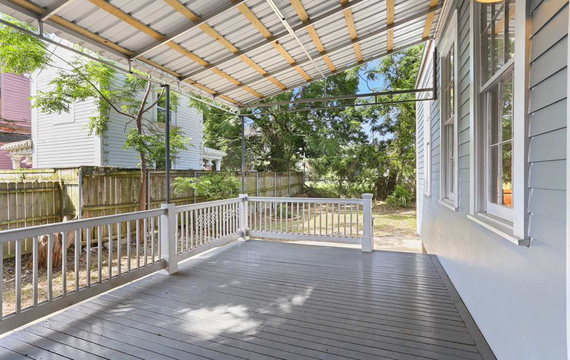 angled view of porch of light blue house