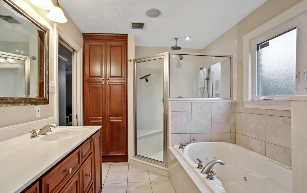 bathroom with sink, tub and walk in shower