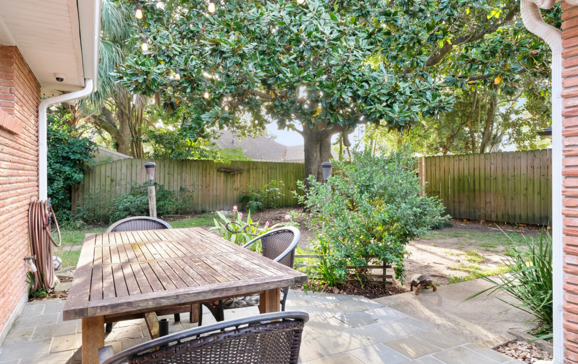 fenced in backyard with seating area