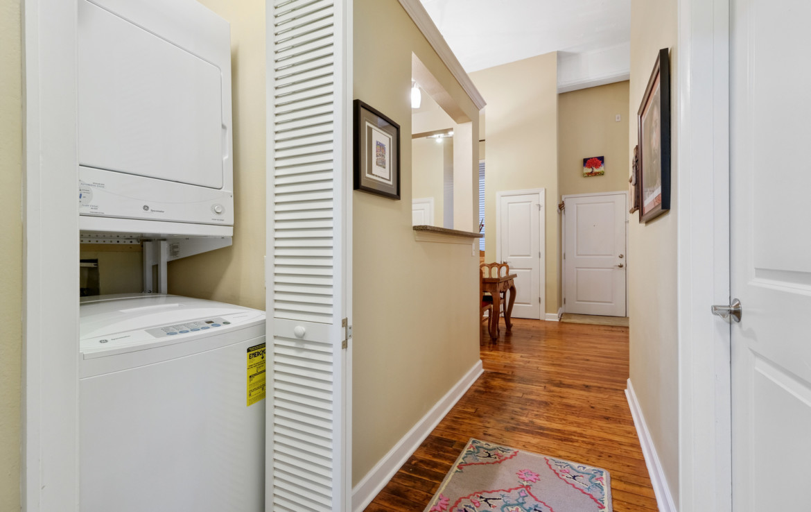 hallway with washer and dryer on the left