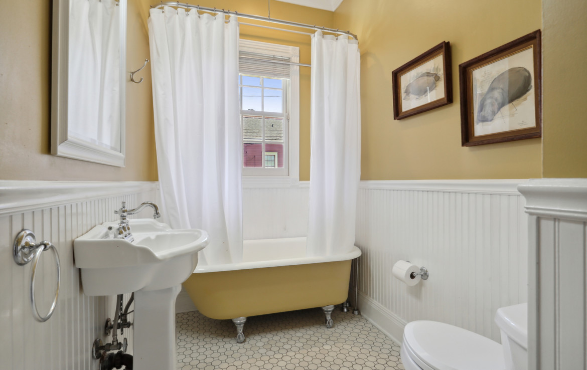 Bathroom with clawfoot tub and yellow paint