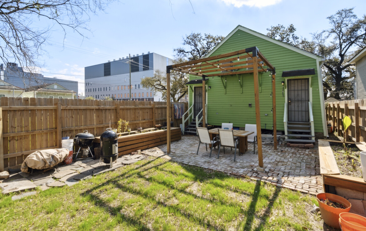 Backyard with paved patio facing house