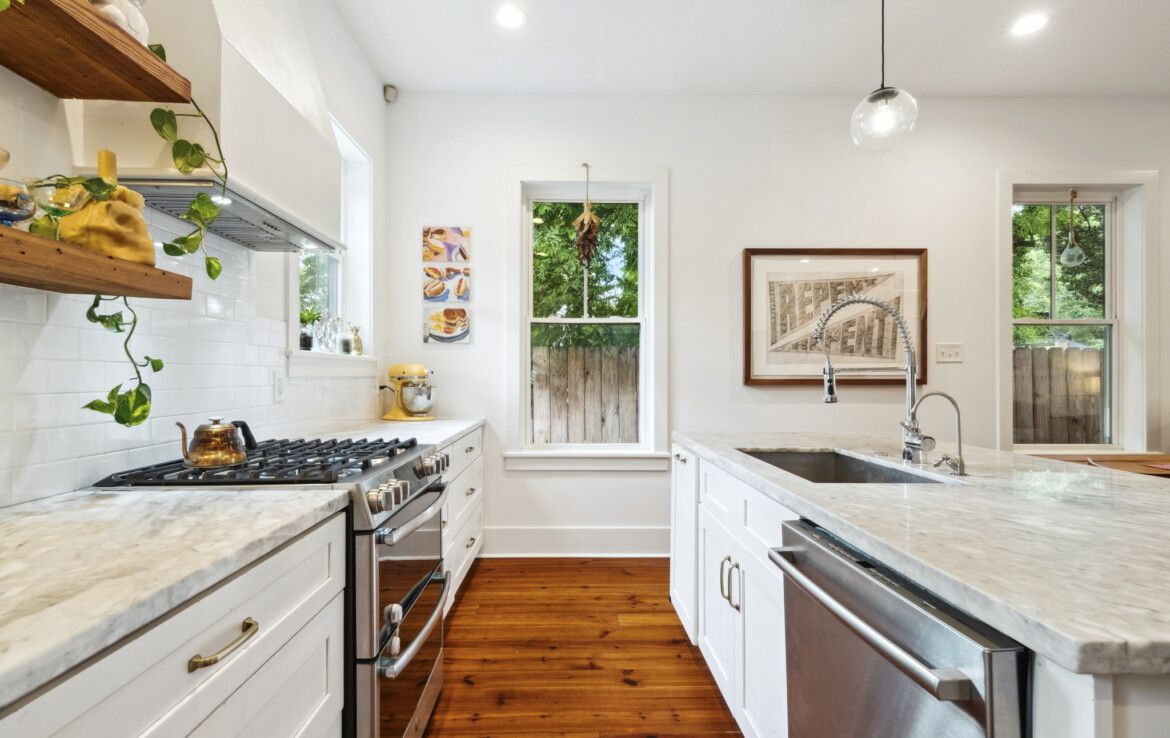 MLS-9-kitchen-close-up-marble-counters-backsplash-stove-dishwasher