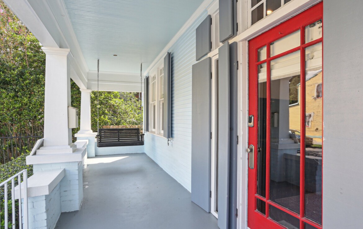 Covered porch close up red front door