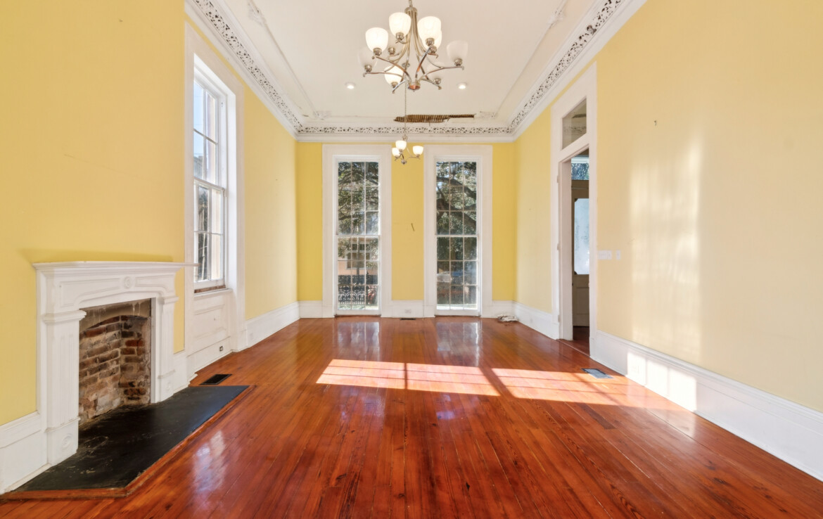 front room yellow walls floor to ceiling windows