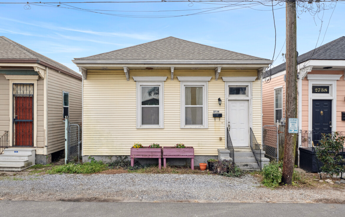 Facade with graveled area in front and view of 6 month old roof!