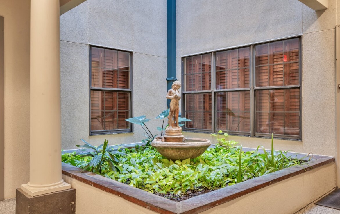 Enjoy gardens within the building's courtyard