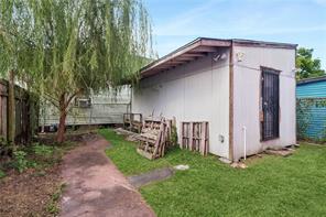 backyard of bike shop fenced in shed