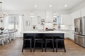 bright open kitchen, black island, large windows
